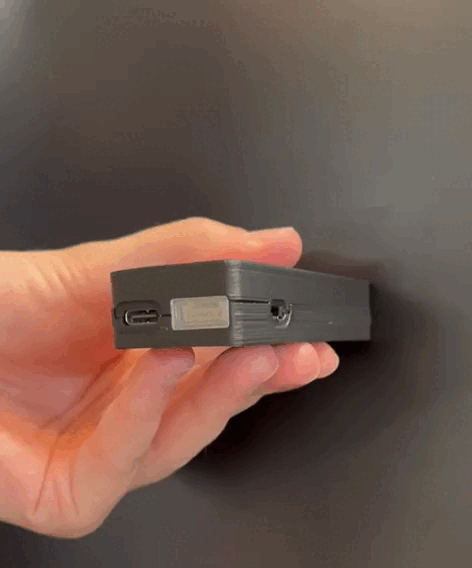 The red charging LED lit behind the cover of the MAVLink port