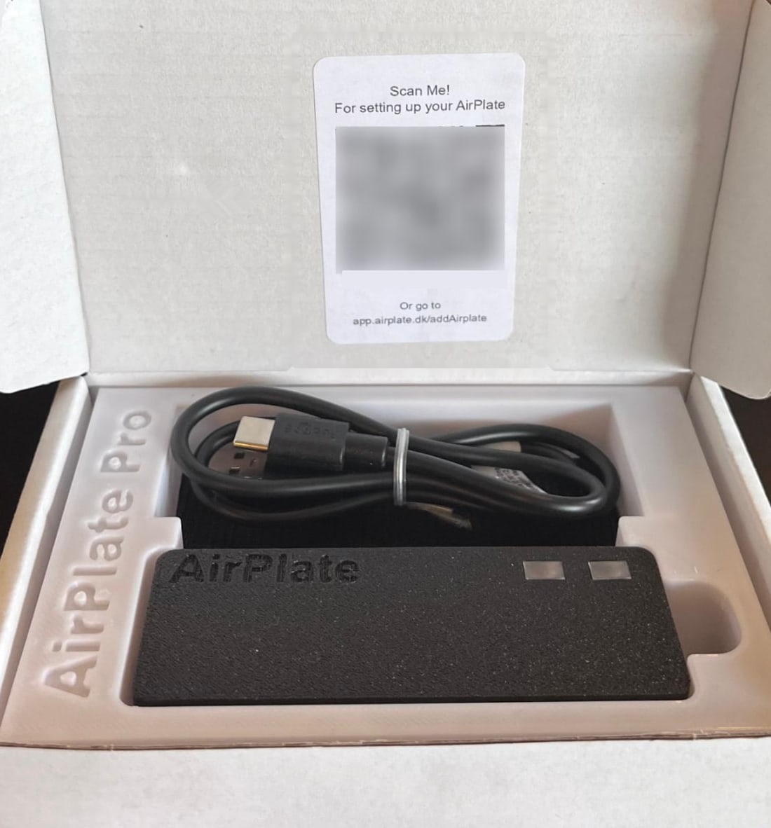 The opened Remote ID Pro box, with the QR code card inside the lid