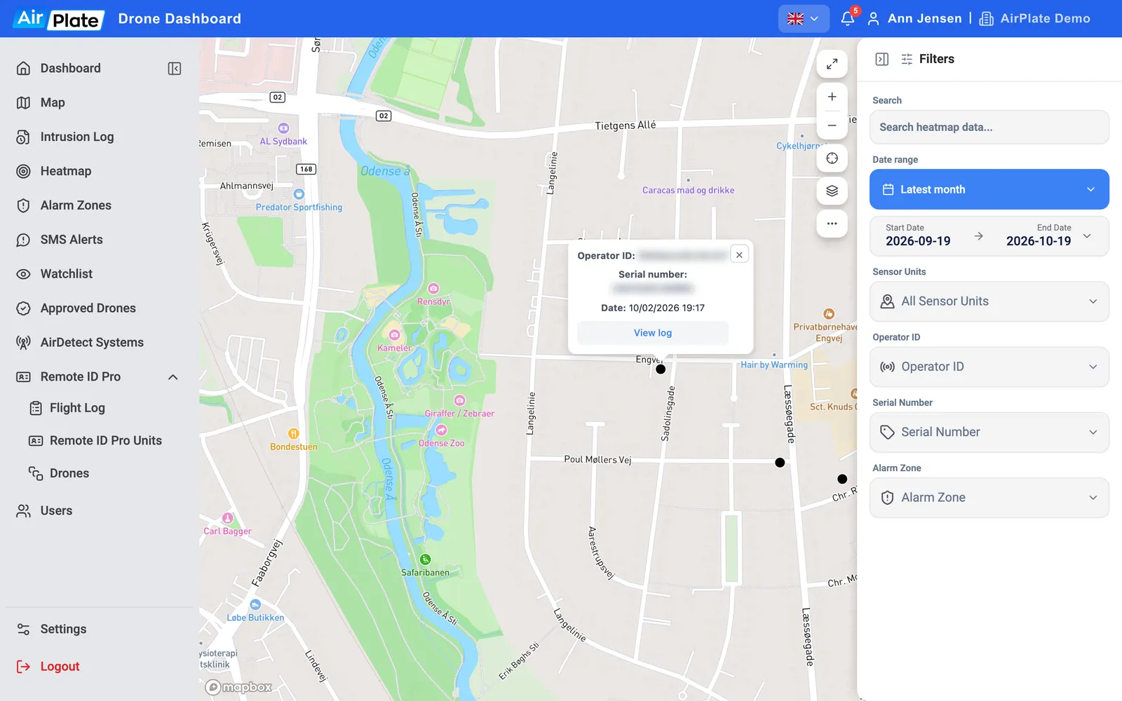 The Heatmap zoomed in to street level: flights as black dots, one with a popup showing its operator ID, serial number, date and View log