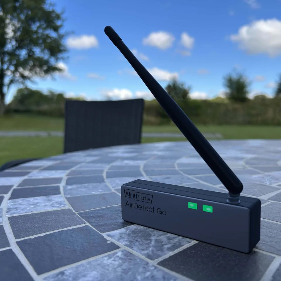 AirDetect Go with its integrated antenna up, on an outdoor table