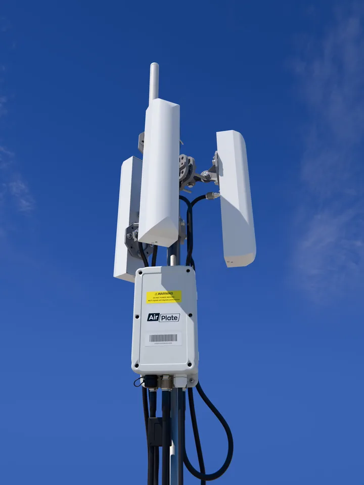 AirDetect Long Range on a mast: three tri-sector antennas and an omni antenna above the sensor enclosure