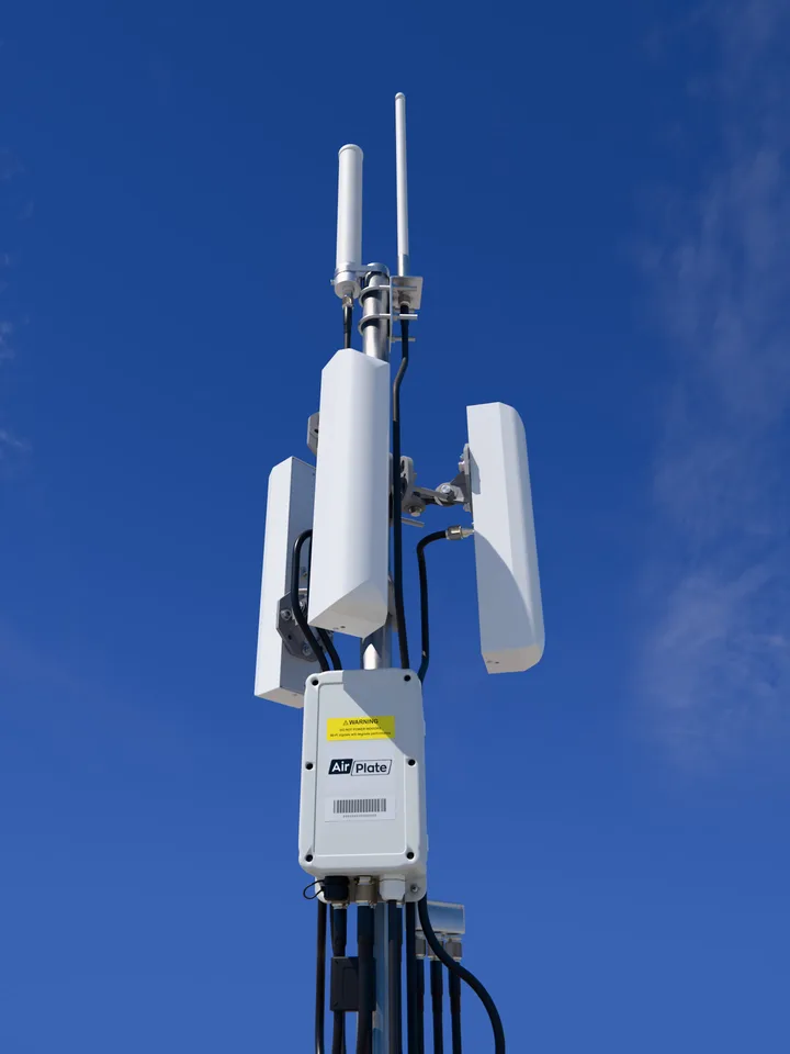 AirDetect Pro Long Range on a mast: three tri-sector antennas and two rod antennas above the sensor enclosure